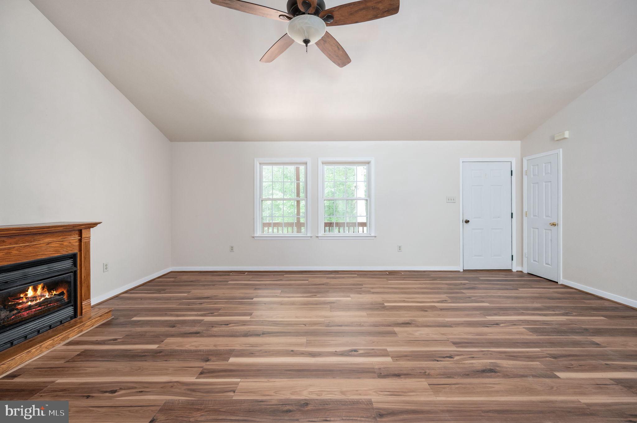 1822 Copper Line Road Bumpass, VA 23024 - Photo 13 of 65 a view of an empty room with a window and fireplace