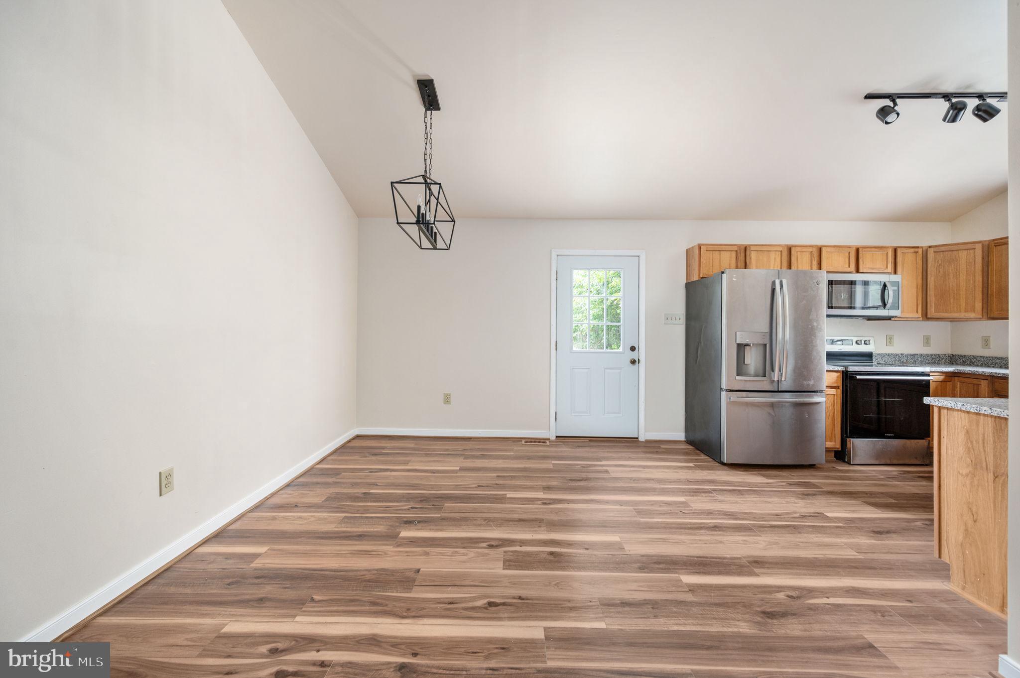 1822 Copper Line Road Bumpass, VA 23024 - Photo 18 of 65 a view of a kitchen with a sink and stainless steel appliances