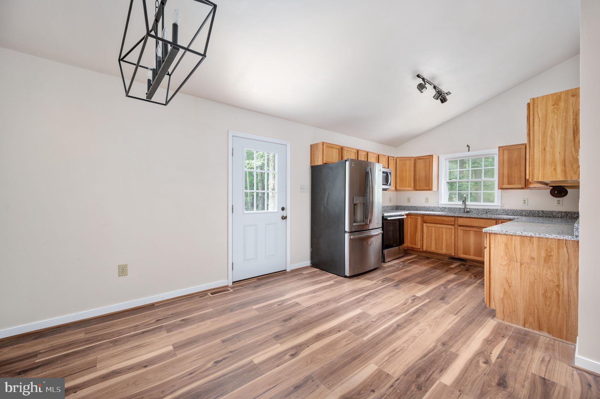 1822 Copper Line Road Bumpass, VA 23024 - Photo 20 of 65 a kitchen with stainless steel appliances a refrigerator and a sink