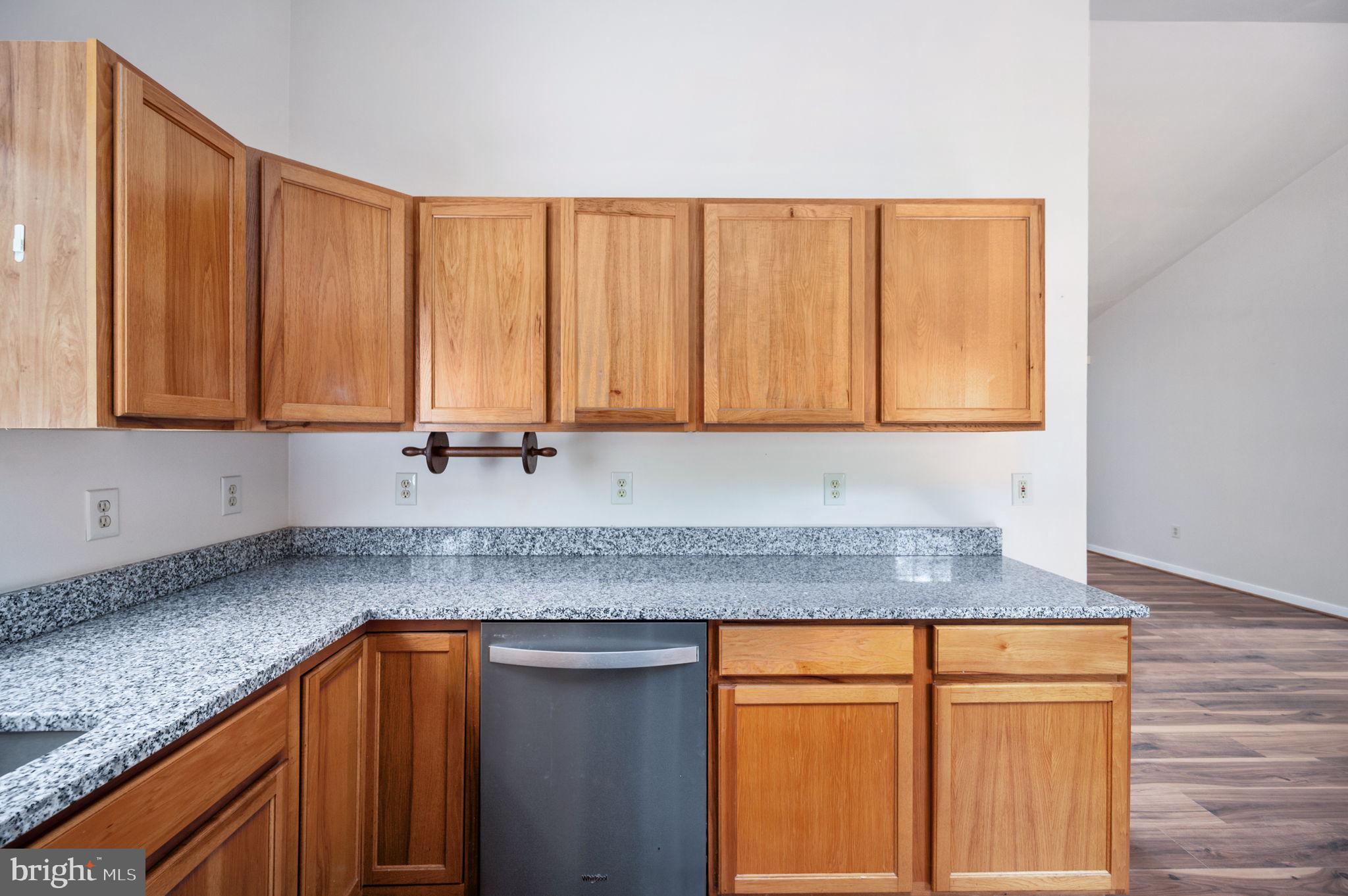 1822 Copper Line Road Bumpass, VA 23024 - Photo 25 of 65 a kitchen with stainless steel appliances granite countertop wooden cabinets a sink and dishwasher