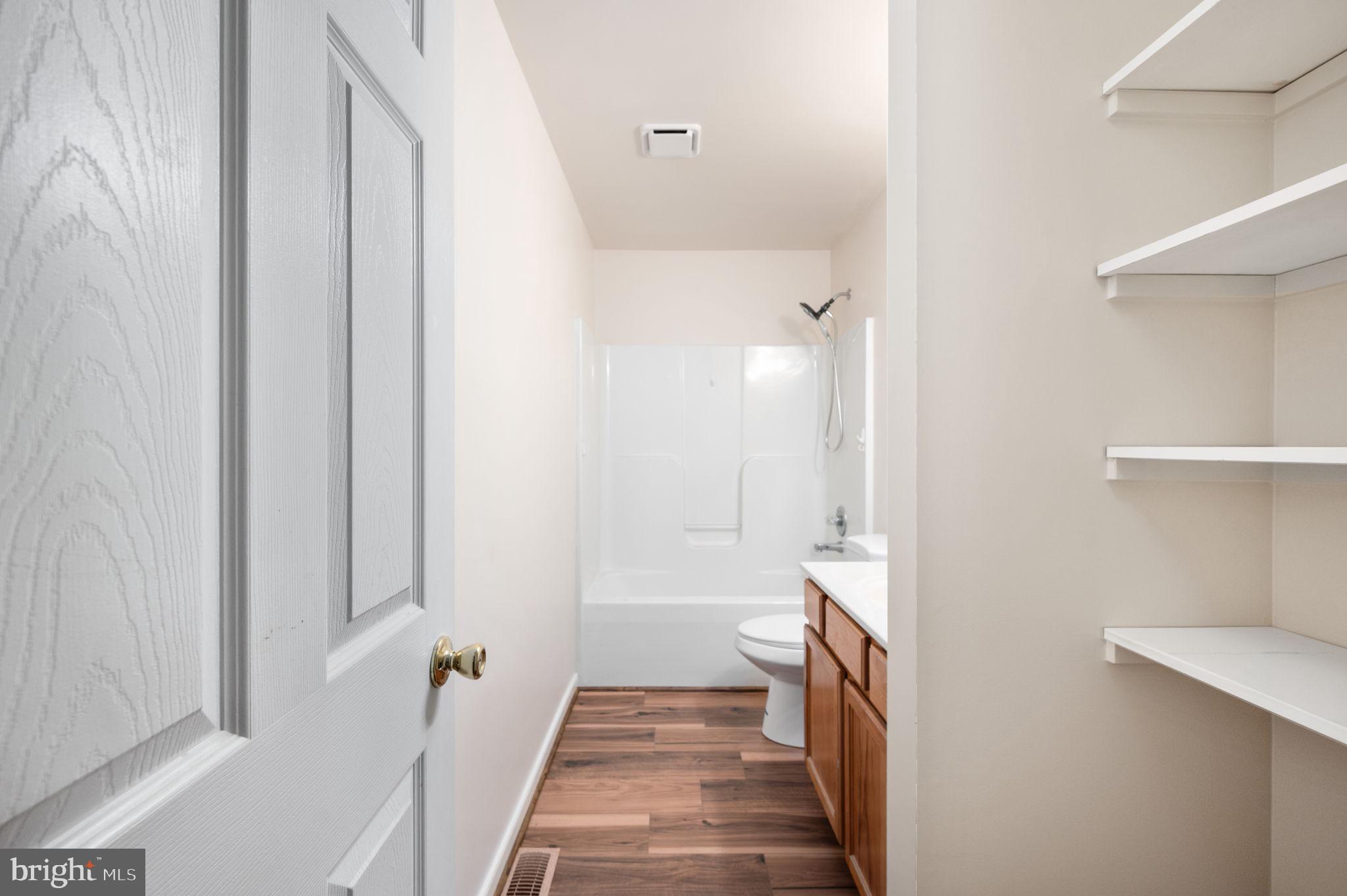 1822 Copper Line Road Bumpass, VA 23024 - Photo 26 of 65 a bathroom with a sink a toilet and shower