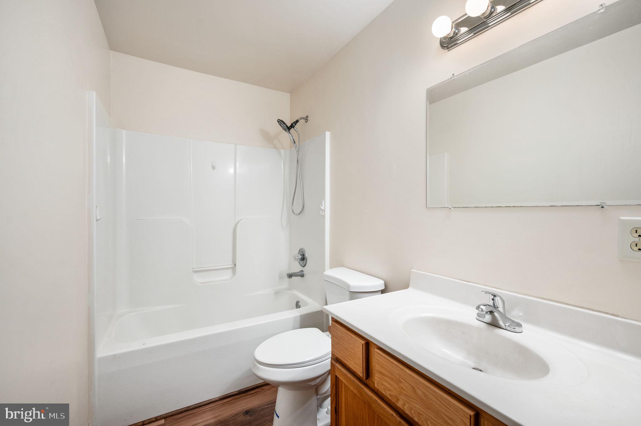 1822 Copper Line Road Bumpass, VA 23024 - Photo 27 of 65 a bathroom with a sink toilet and a bathtub