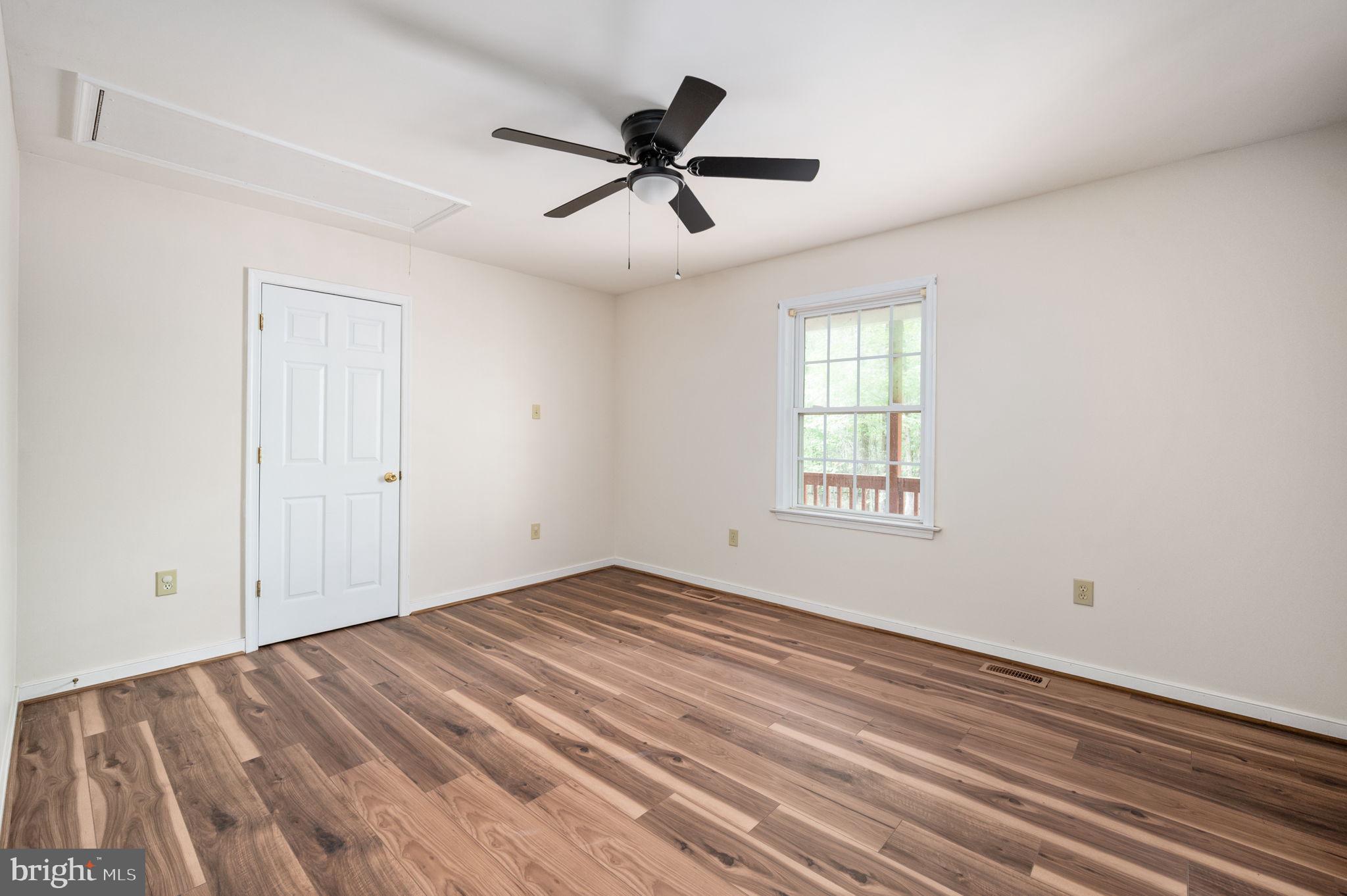 1822 Copper Line Road Bumpass, VA 23024 - Photo 30 of 65 a view of empty room with wooden floor and fan