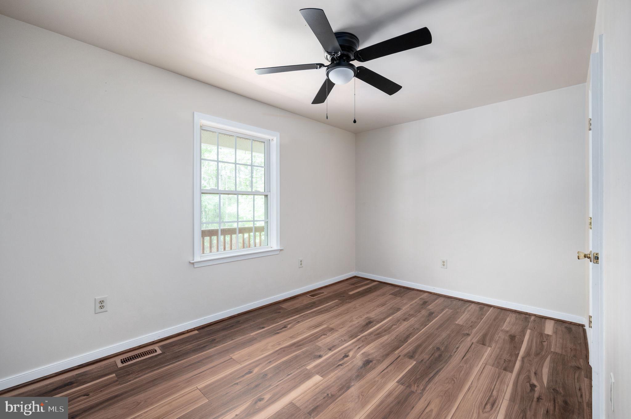 1822 Copper Line Road Bumpass, VA 23024 - Photo 33 of 65 a view of a big room with wooden floor and windows