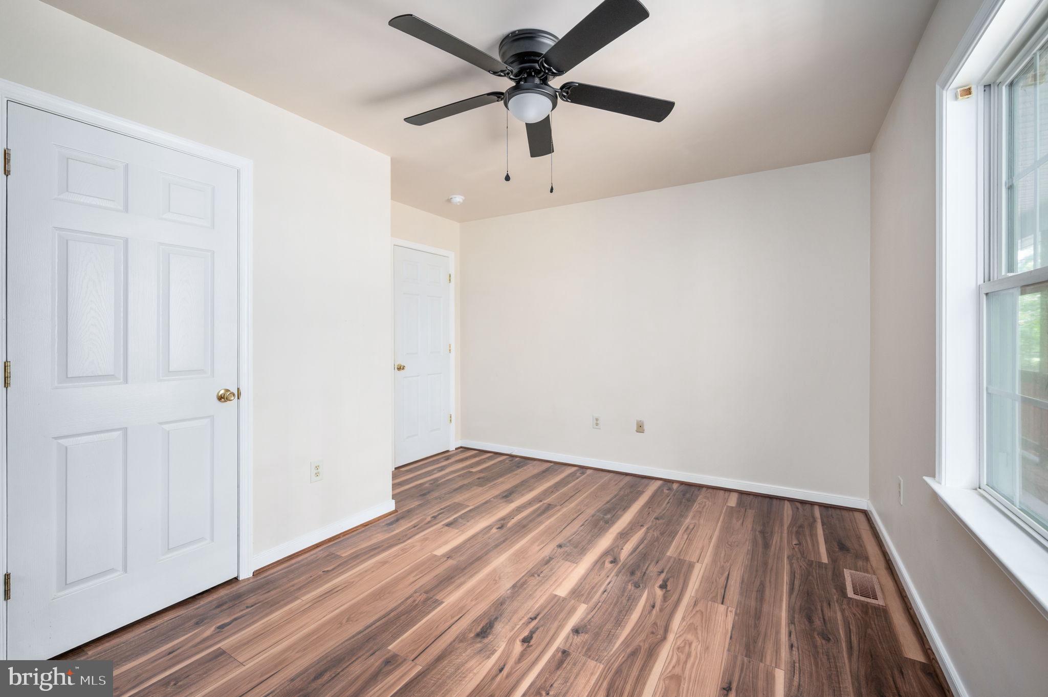1822 Copper Line Road Bumpass, VA 23024 - Photo 34 of 65 wooden floor in an empty room with a window