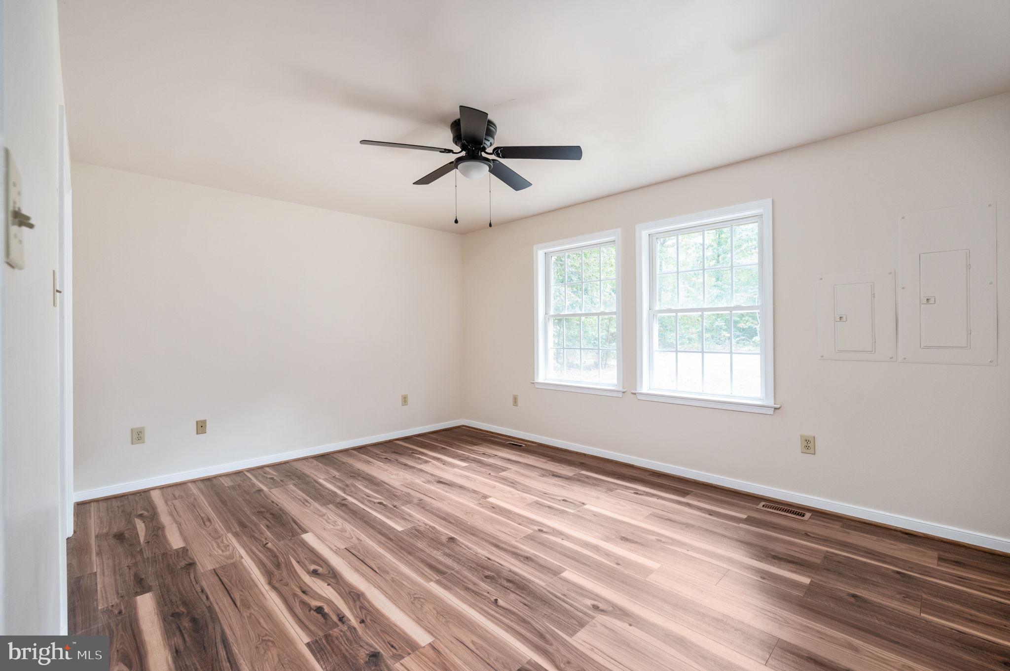 1822 Copper Line Road Bumpass, VA 23024 - Photo 35 of 65 a view of empty room with wooden floor and fan
