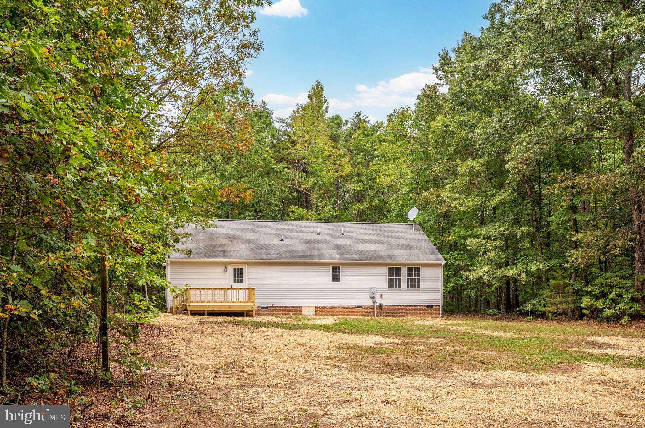 1822 Copper Line Road Bumpass, VA 23024 - Photo 47 of 65 a front view of a house with a yard and garage