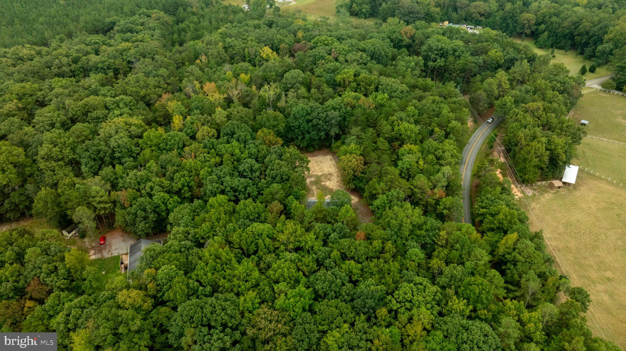 1822 Copper Line Road Bumpass, VA 23024 - Photo 49 of 65 an aerial view of residential house with outdoor space and trees all around