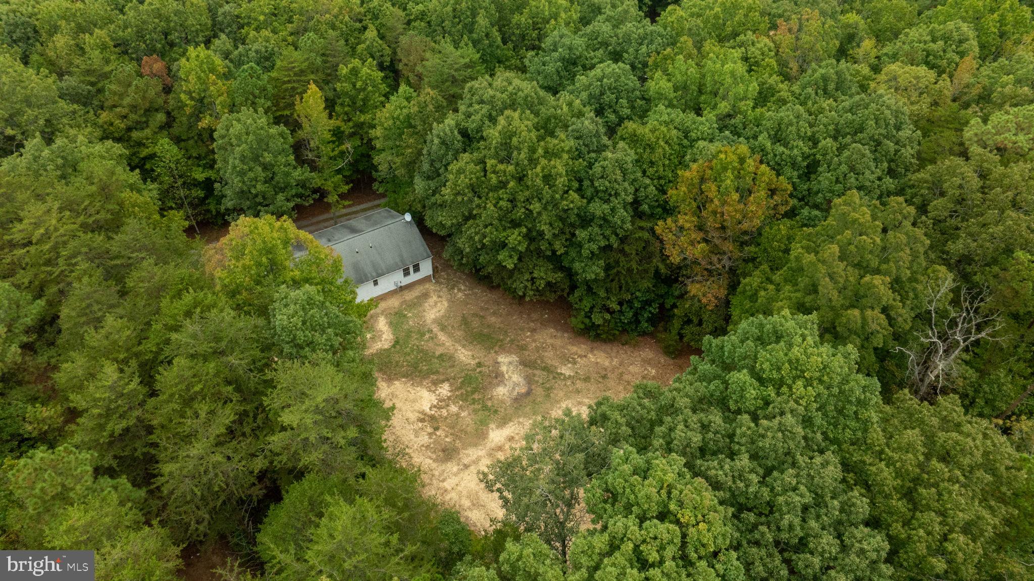 1822 Copper Line Road Bumpass, VA 23024 - Photo 61 of 65 an aerial view of residential house with outdoor space and trees all around
