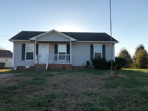 a view of a house with yard and a garden