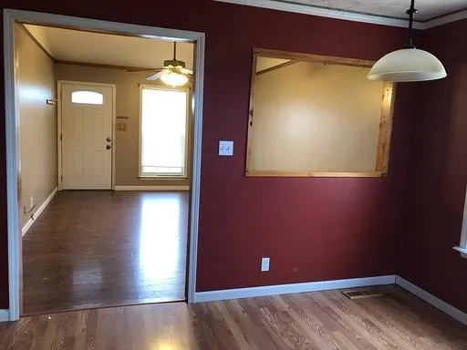 a view of a room with wooden floor and a cabinet
