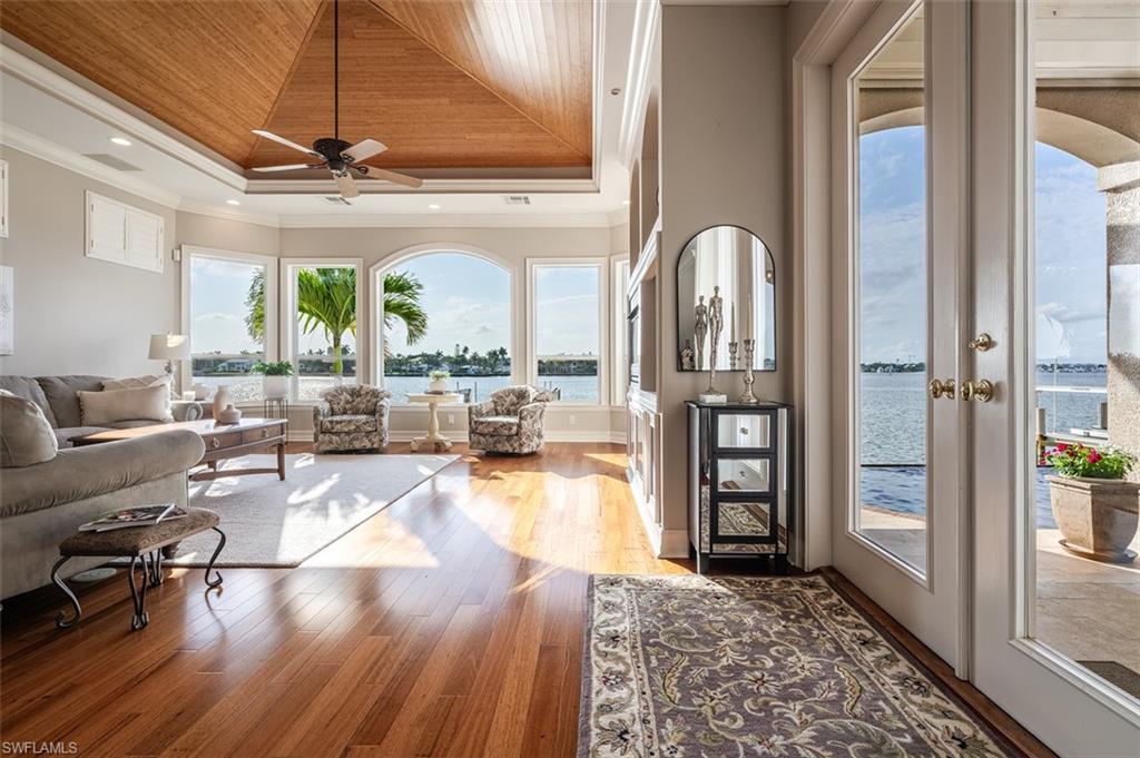 1942 Kingfish Road Naples, FL 34102 - Photo 10 of 43 a living room with fireplace furniture and a large window