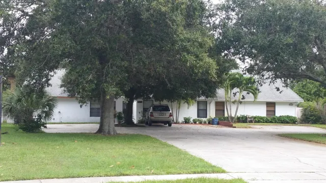 a front view of house with yard and green space