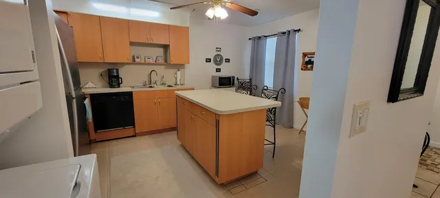 a utility room with cabinets washer and dryer