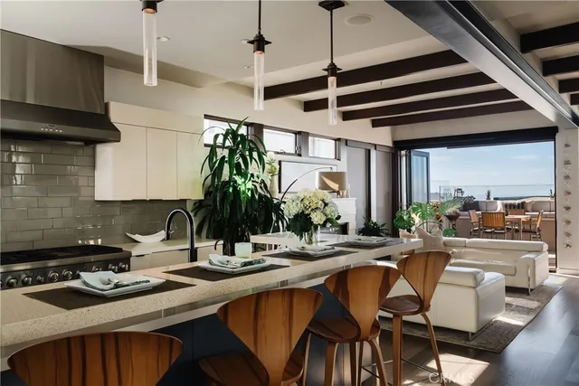 a kitchen with a sink a stove and chairs