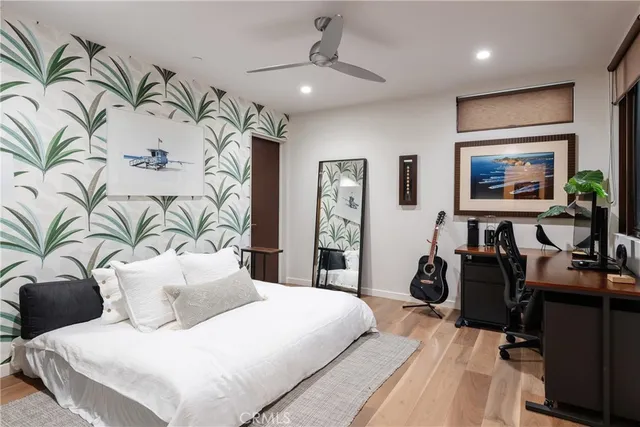 a bedroom with a large bed and a potted plant