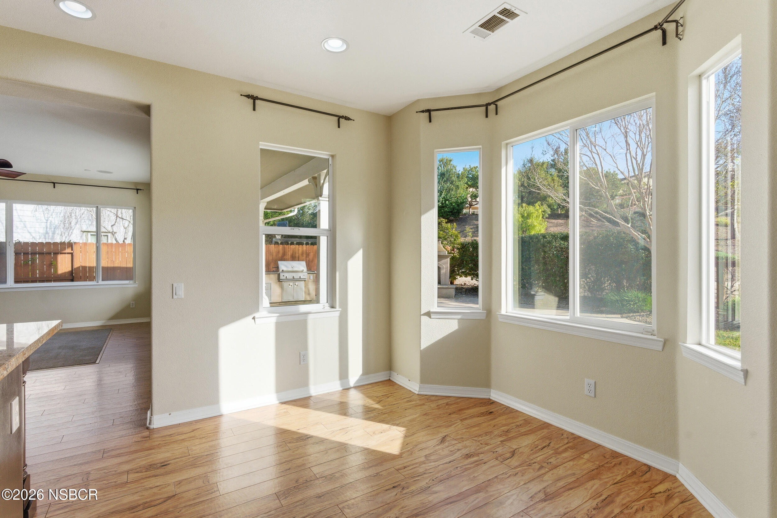 5632 Menemsha Lane Santa Maria, CA 93455 - Photo 12 of 66 a view of an empty room with wooden floor and a window