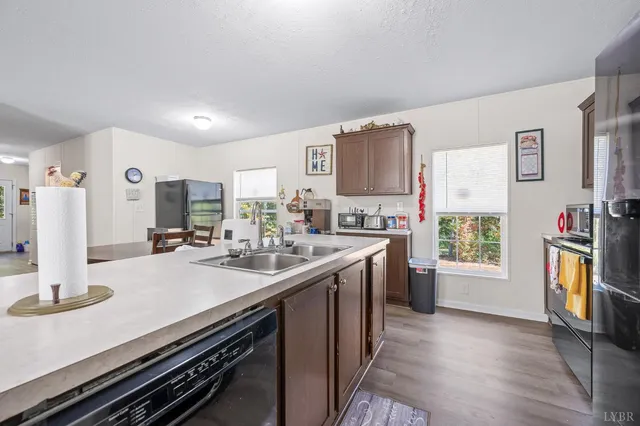 a kitchen with a sink appliances and cabinets