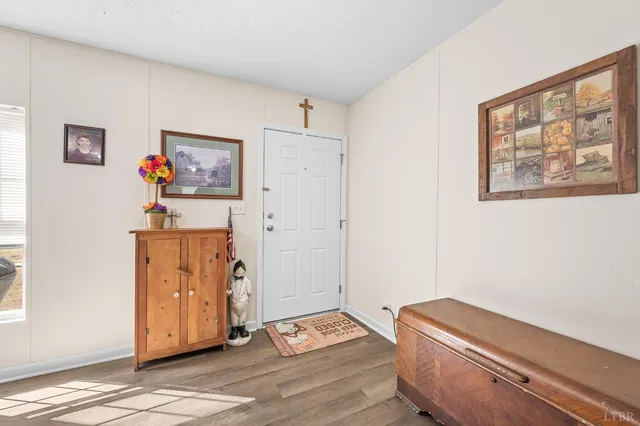 a room with painting on the wall and a window