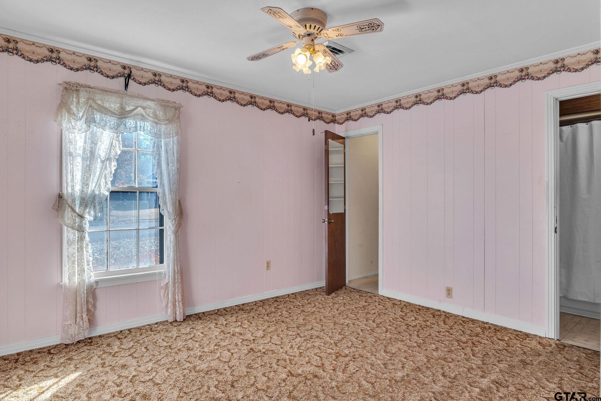 501 Samuel Street Marshall, TX 75672 - Photo 10 of 41 a view of a livingroom with a ceiling fan and window