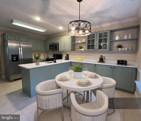 a kitchen with a dining table and chairs