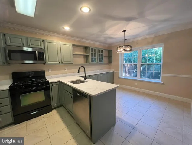 a kitchen with a stove sink and microwave