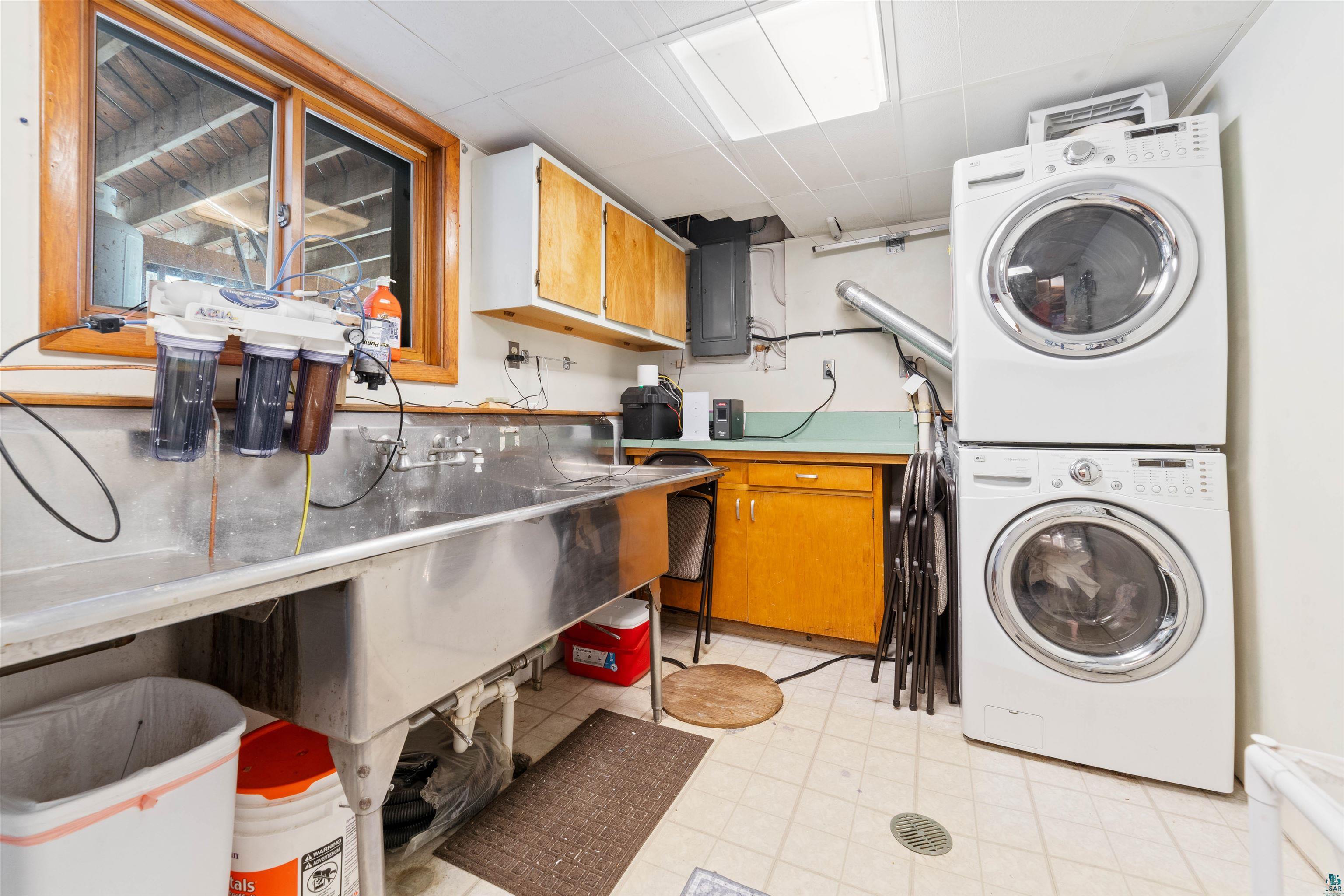 6949 County Rd A Superior, WI 54880 - Photo 20 of 34 Laundry room with cabinets, stacked washer / drying machine, and electric panel