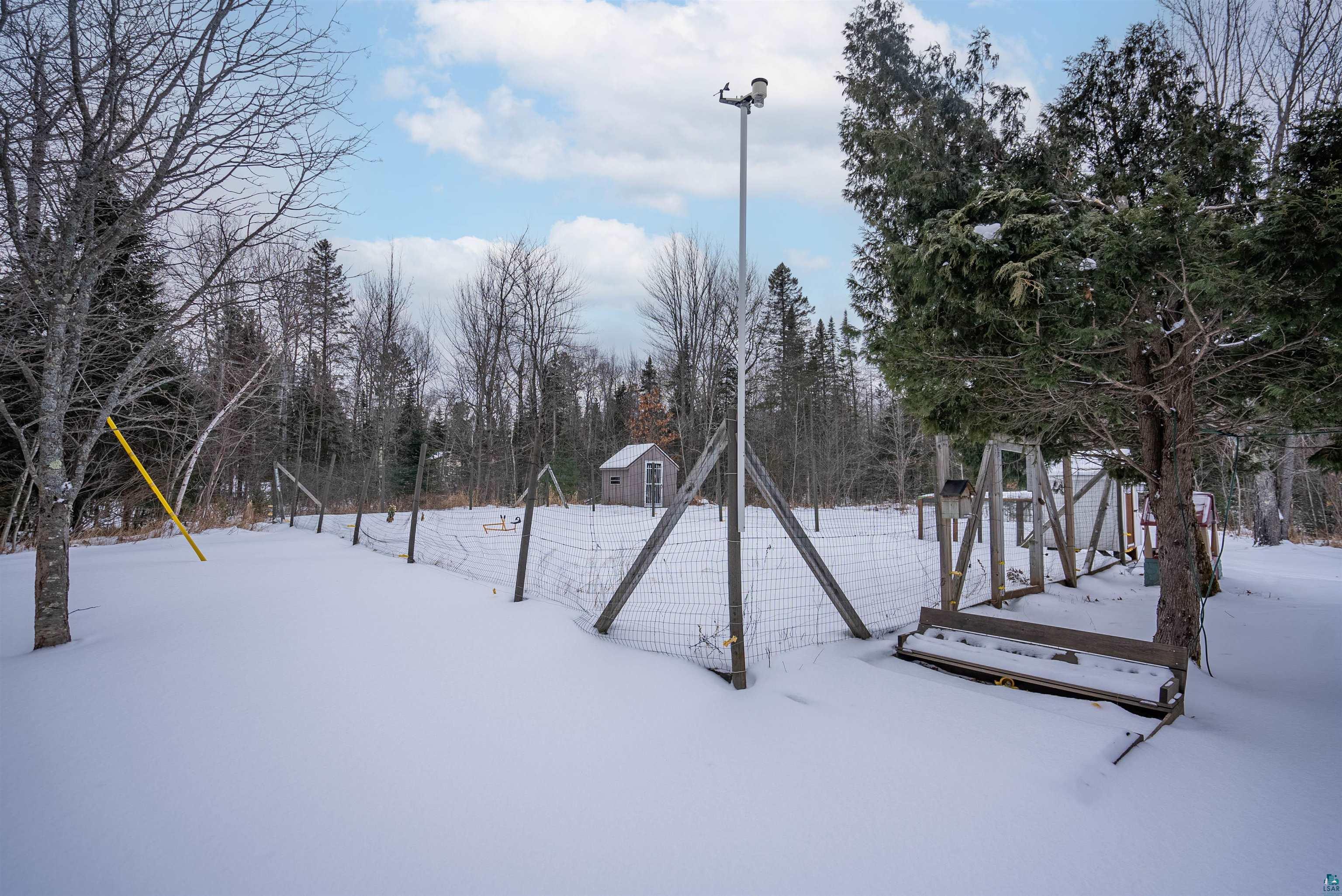 6949 County Rd A Superior, WI 54880 - Photo 26 of 34 Snowy yard featuring a storage shed