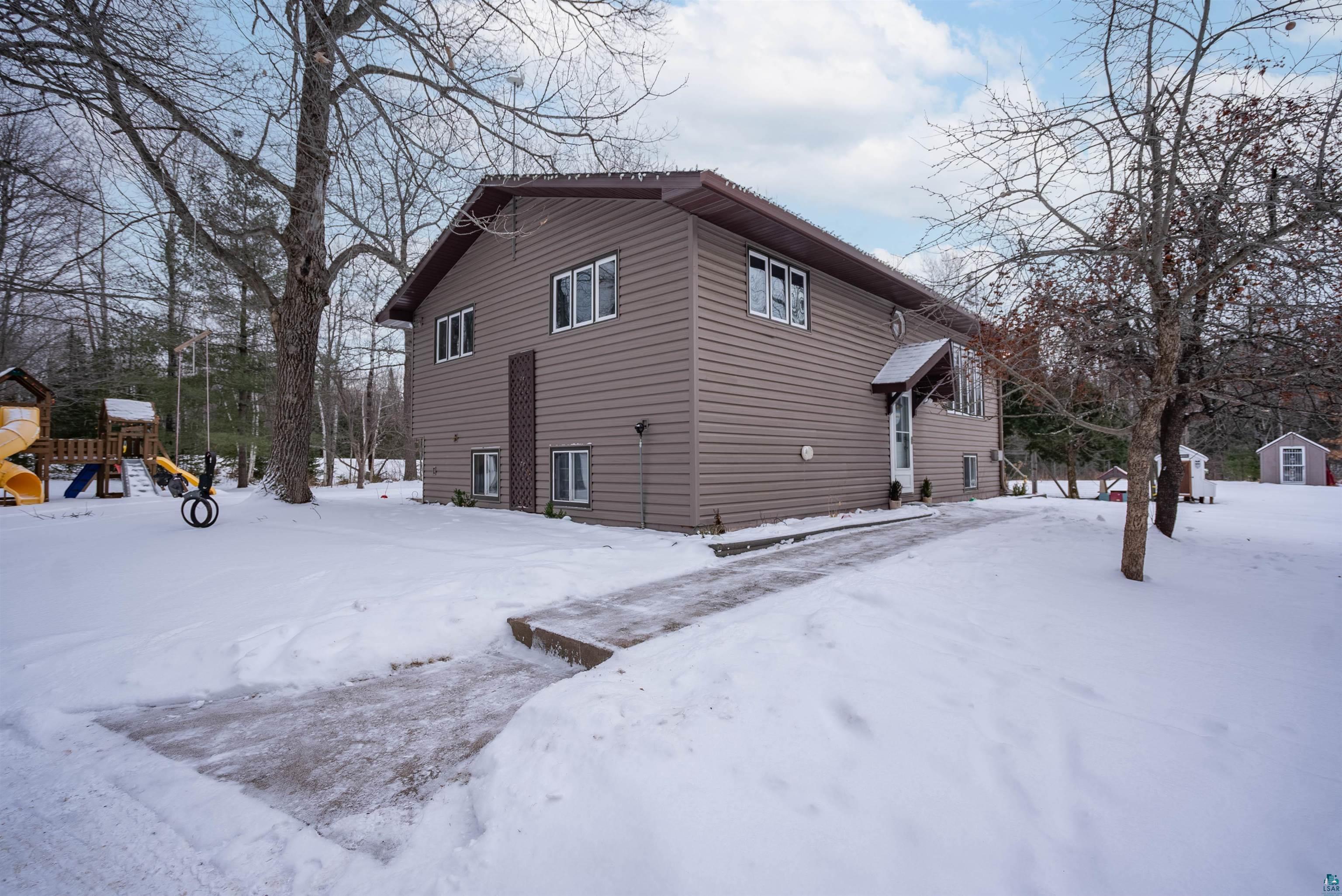 6949 County Rd A Superior, WI 54880 - Photo 27 of 34 View of snow covered exterior with a playground