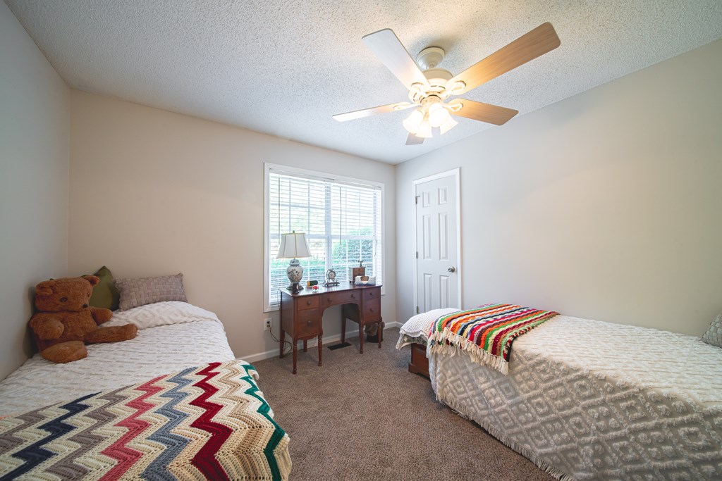 200 Lake Amah Lee Road Hampton, GA 30228 - Photo 19 of 29 a bedroom with a bed and a window