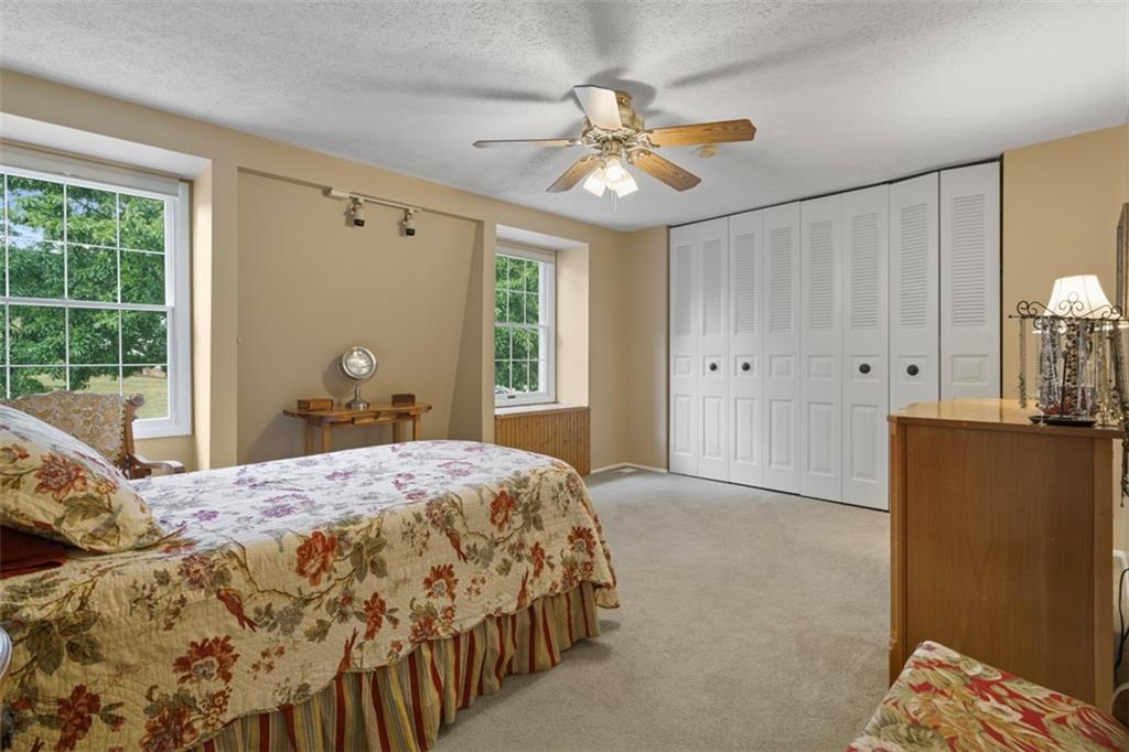 274 Kettering Circle Gibsonia, PA 15044 - Photo 23 of 50 a bedroom with a bed and a chandelier