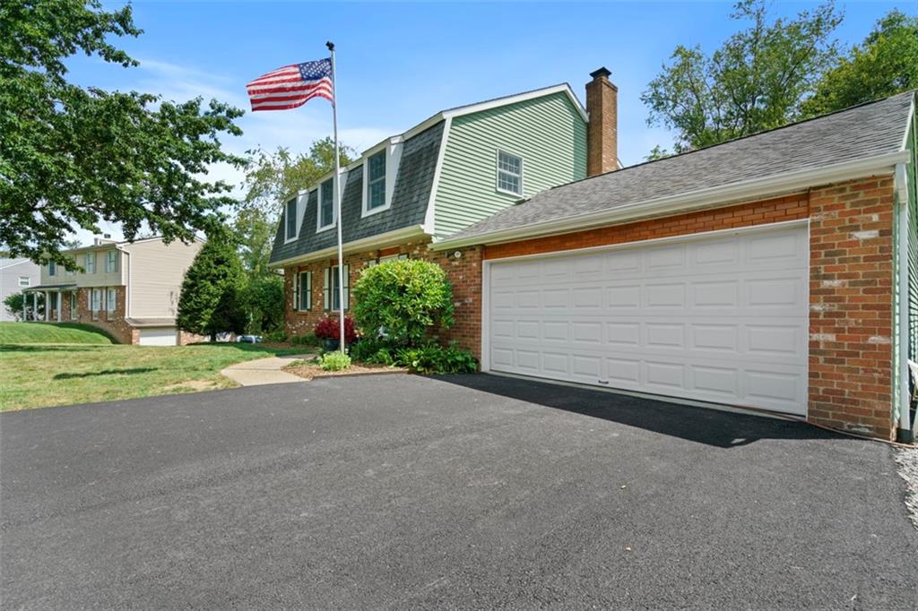 274 Kettering Circle Gibsonia, PA 15044 - Photo 3 of 50 a front view of a house with a yard and garage