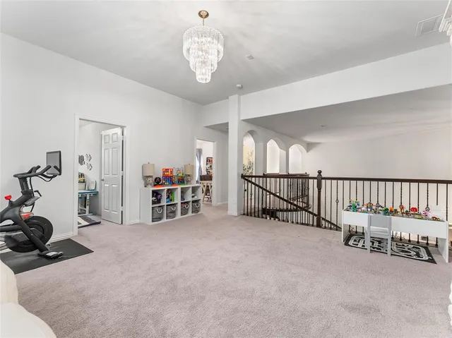 a living room with furniture gym equipment and a flat screen tv
