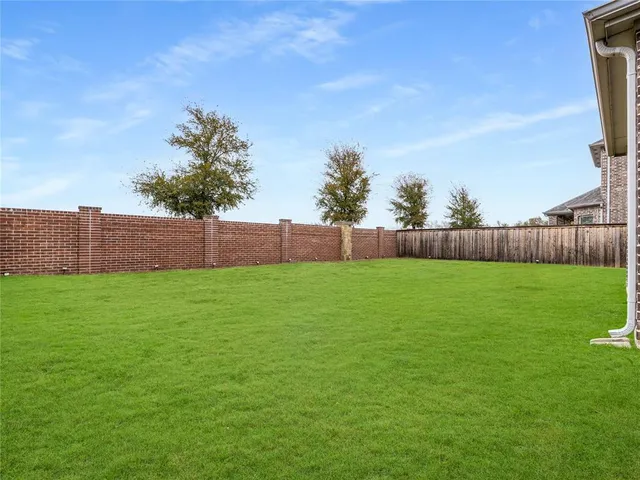 a view of a backyard with a garden and deck