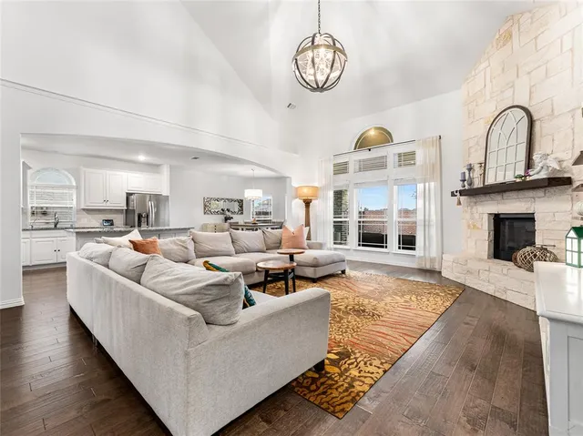 a living room with furniture kitchen view and a fireplace