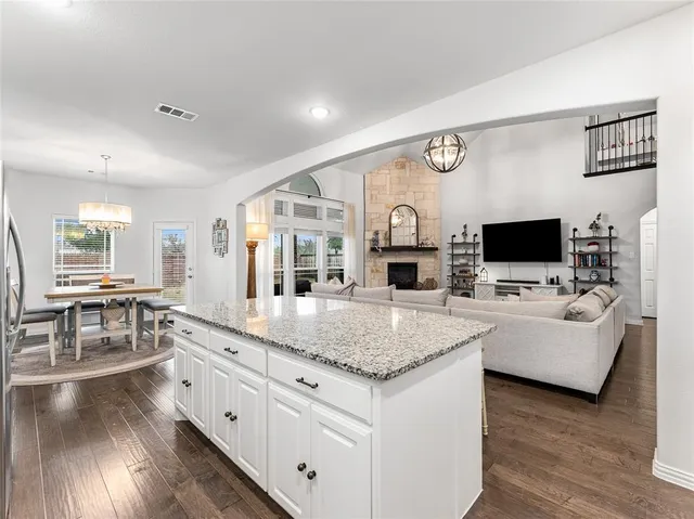 a view of living room with kitchen island furniture and flat screen tv