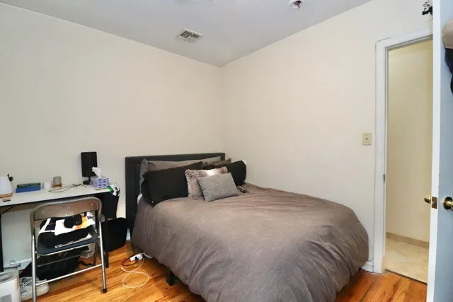 a bedroom with a bed and a night stand