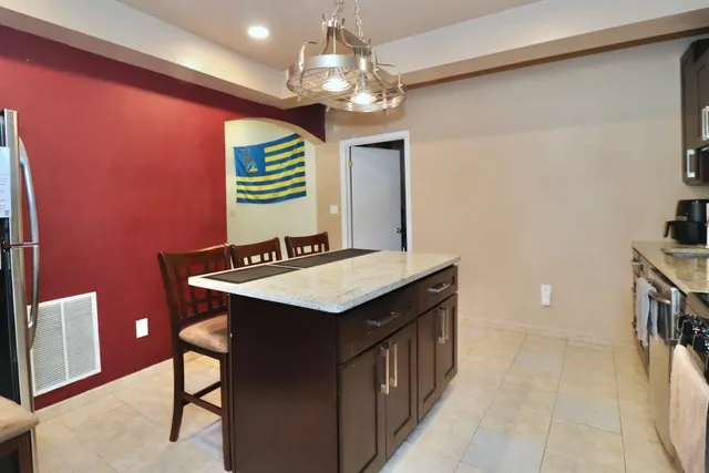 a kitchen that has a sink and a stove in it