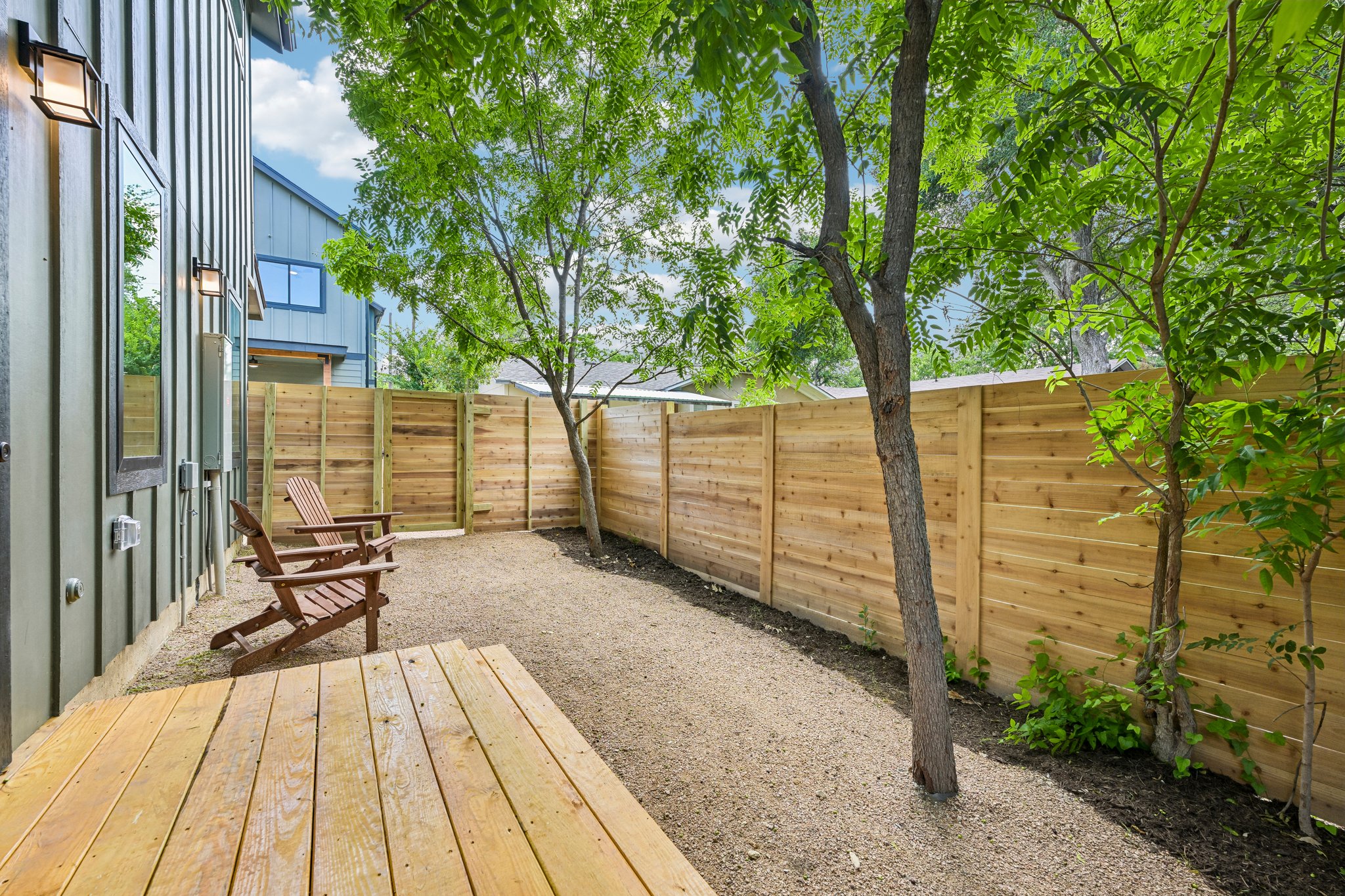 513 West Odell Street, Unit B Austin, TX 78752 - Photo 36 of 38 A private side yard offers a serene outdoor escape with a sturdy wood deck and tall privacy fencing.