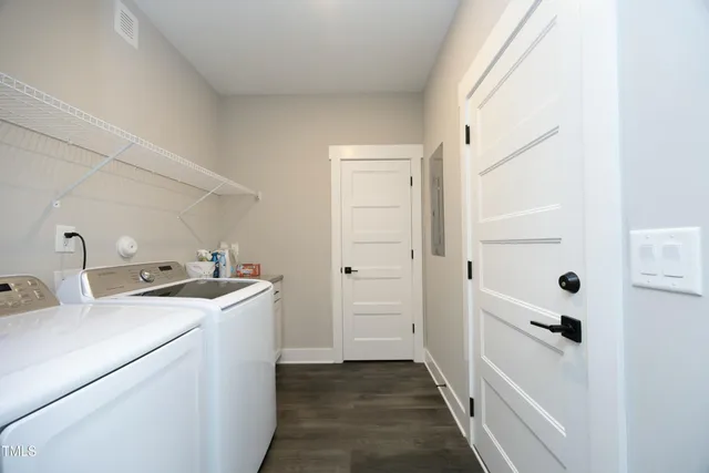 a view of a storage & utility room with dryer and washer