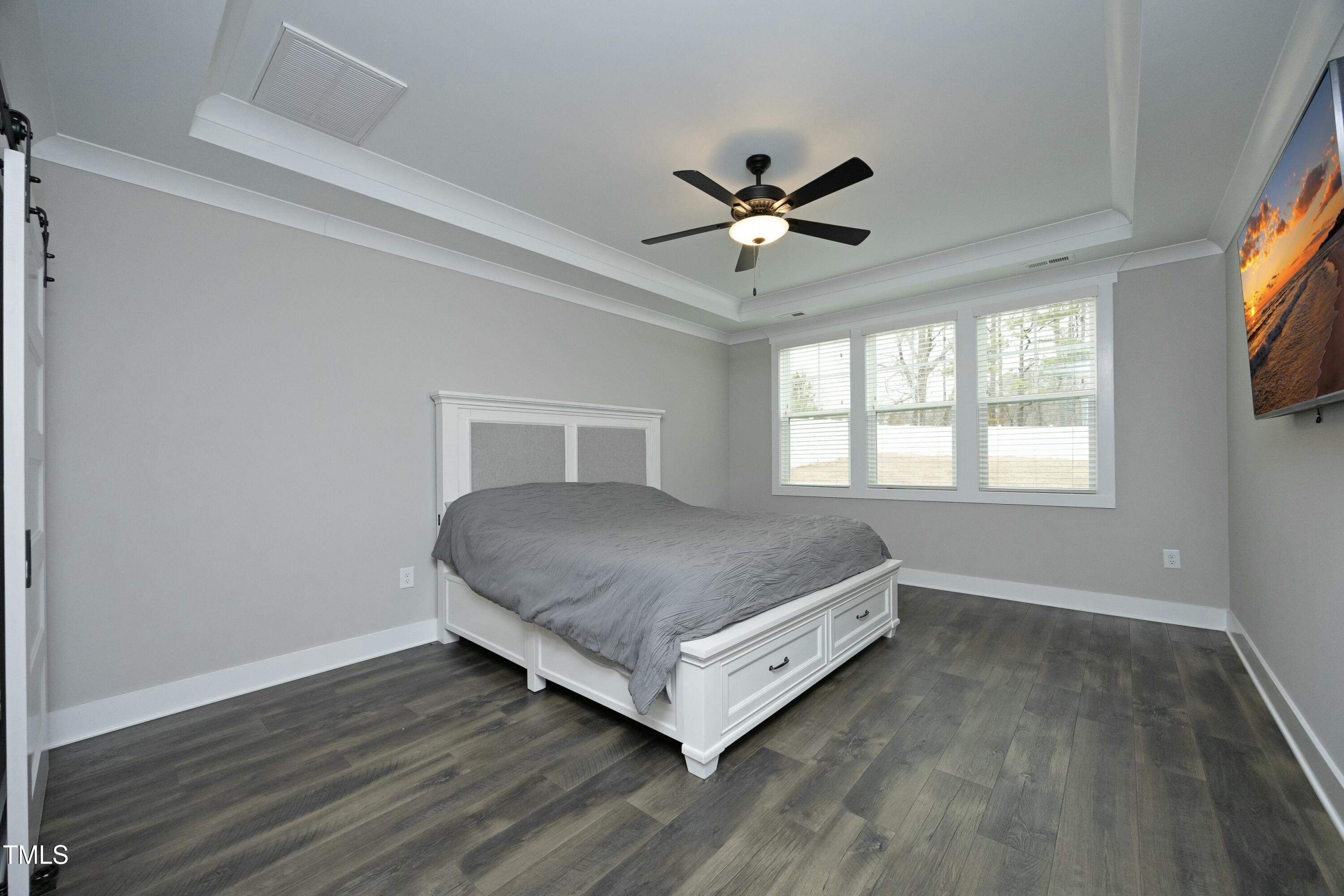 97 Buckstone Place Willow Spring, NC 27592 - Photo 18 of 33 a living room with a bed furniture and a large window