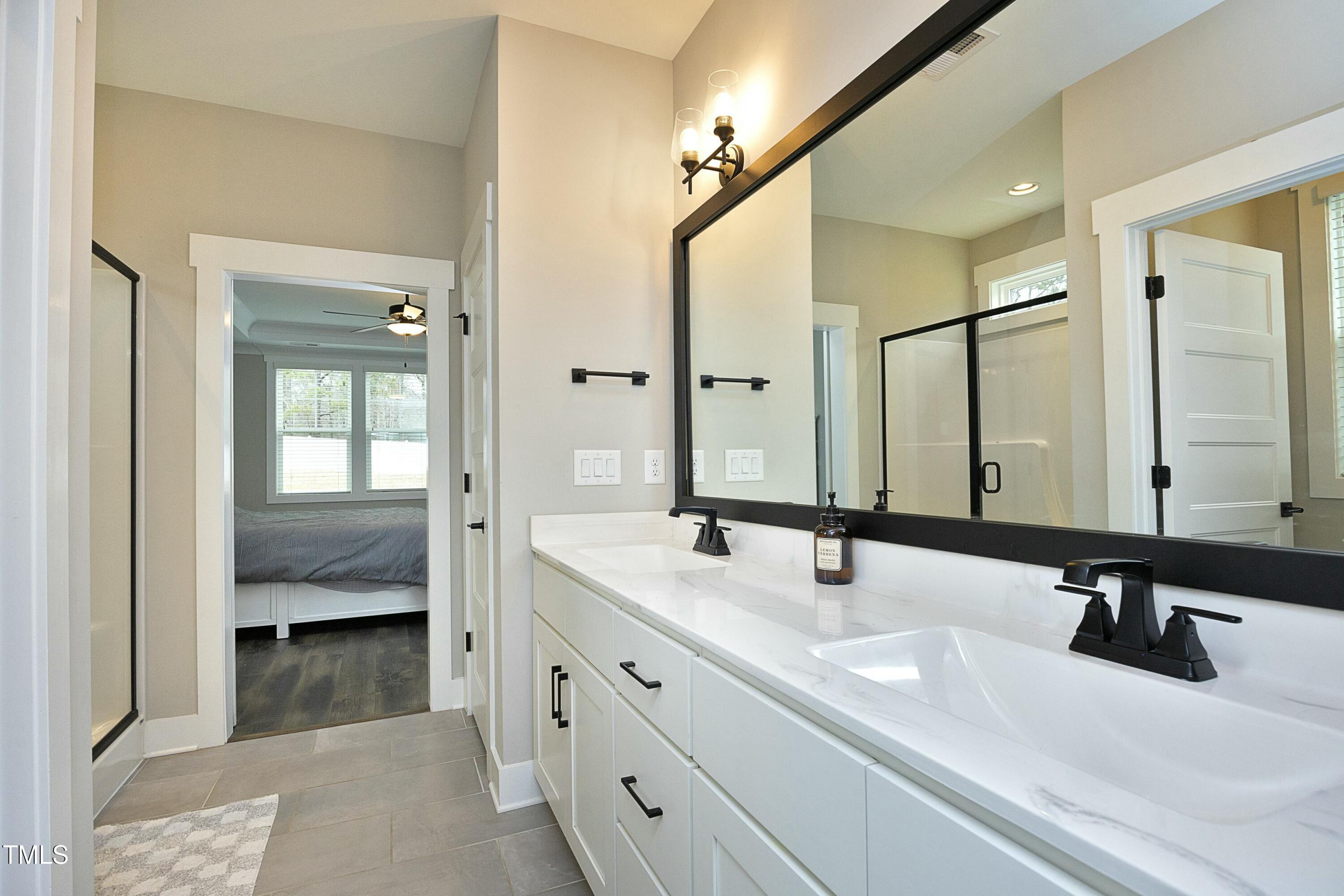 97 Buckstone Place Willow Spring, NC 27592 - Photo 20 of 33 a en suite bathroom with double sink and a mirror