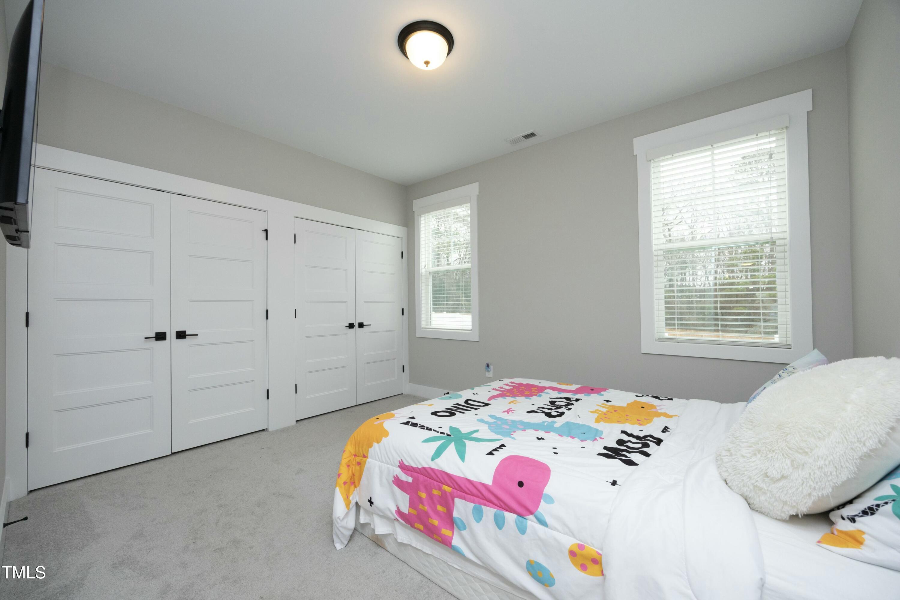 97 Buckstone Place Willow Spring, NC 27592 - Photo 23 of 33 a bedroom with a bed and a window
