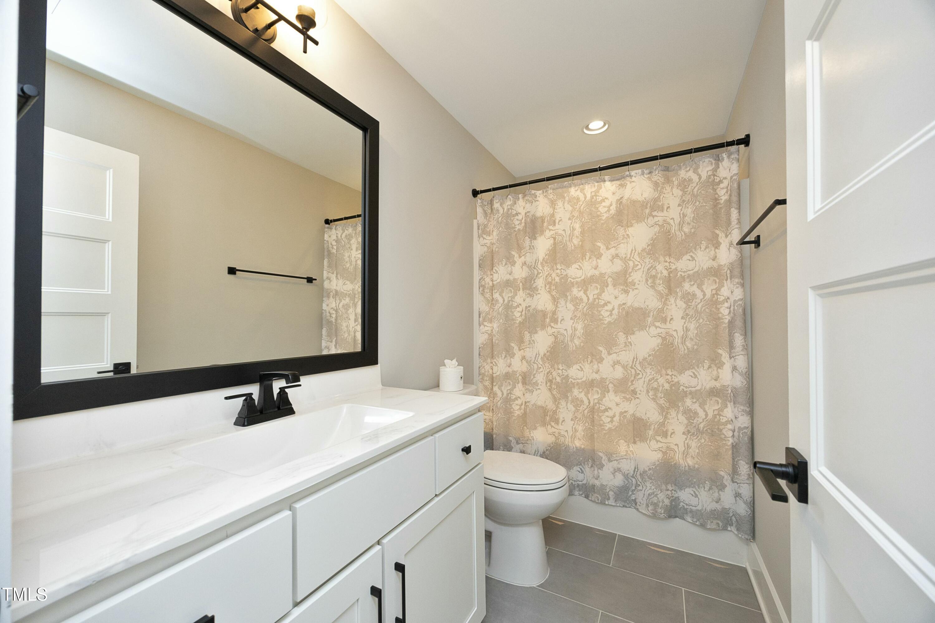 97 Buckstone Place Willow Spring, NC 27592 - Photo 28 of 33 a bathroom with a sink a toilet and shower