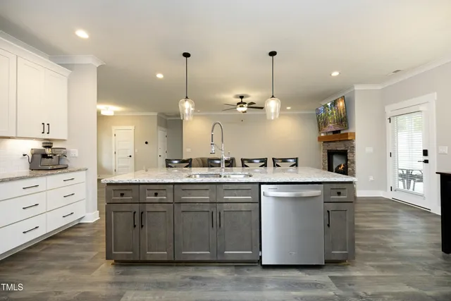a large kitchen with kitchen island a sink stainless steel appliances and cabinets