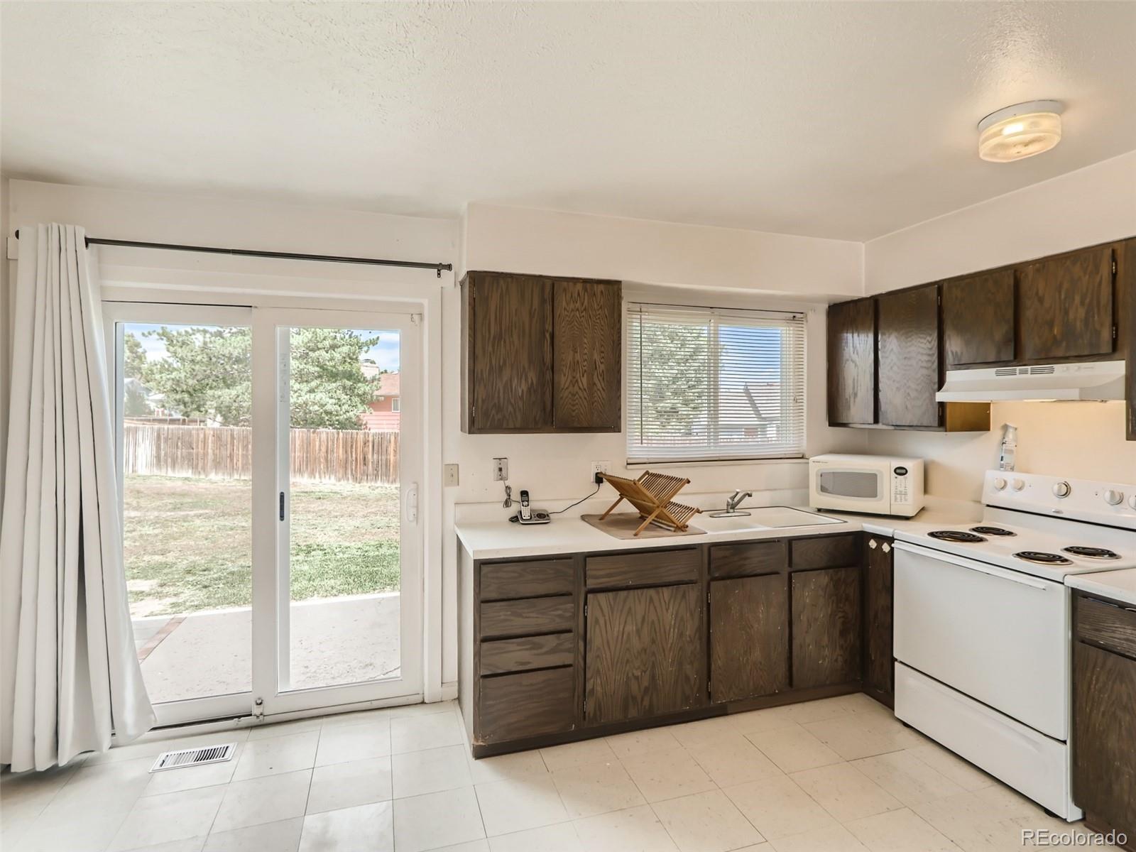 1632 South Rifle Street Aurora, CO 80017 - Photo 13 of 26 a kitchen with a sink and a stove top oven