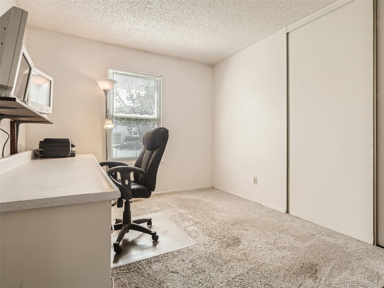 1632 South Rifle Street Aurora, CO 80017 - Photo 15 of 26 a view of a workspace with furniture and a window