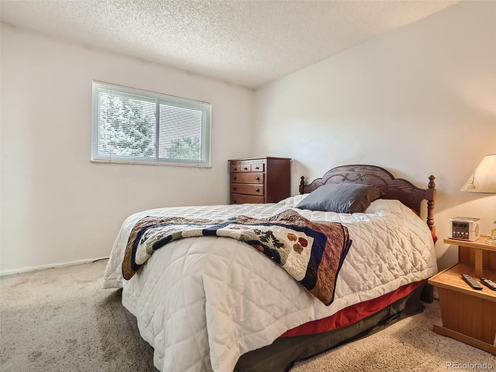 1632 South Rifle Street Aurora, CO 80017 - Photo 17 of 26 a bedroom with a bed and painting on the wall