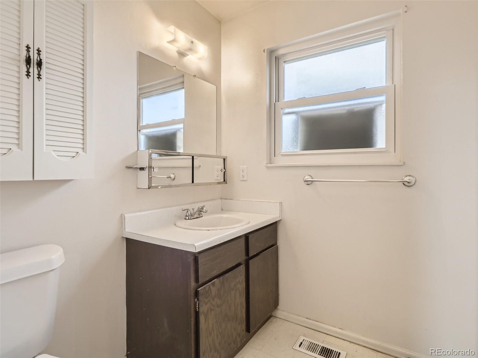1632 South Rifle Street Aurora, CO 80017 - Photo 19 of 26 a bathroom with a sink a vanity and a toilet
