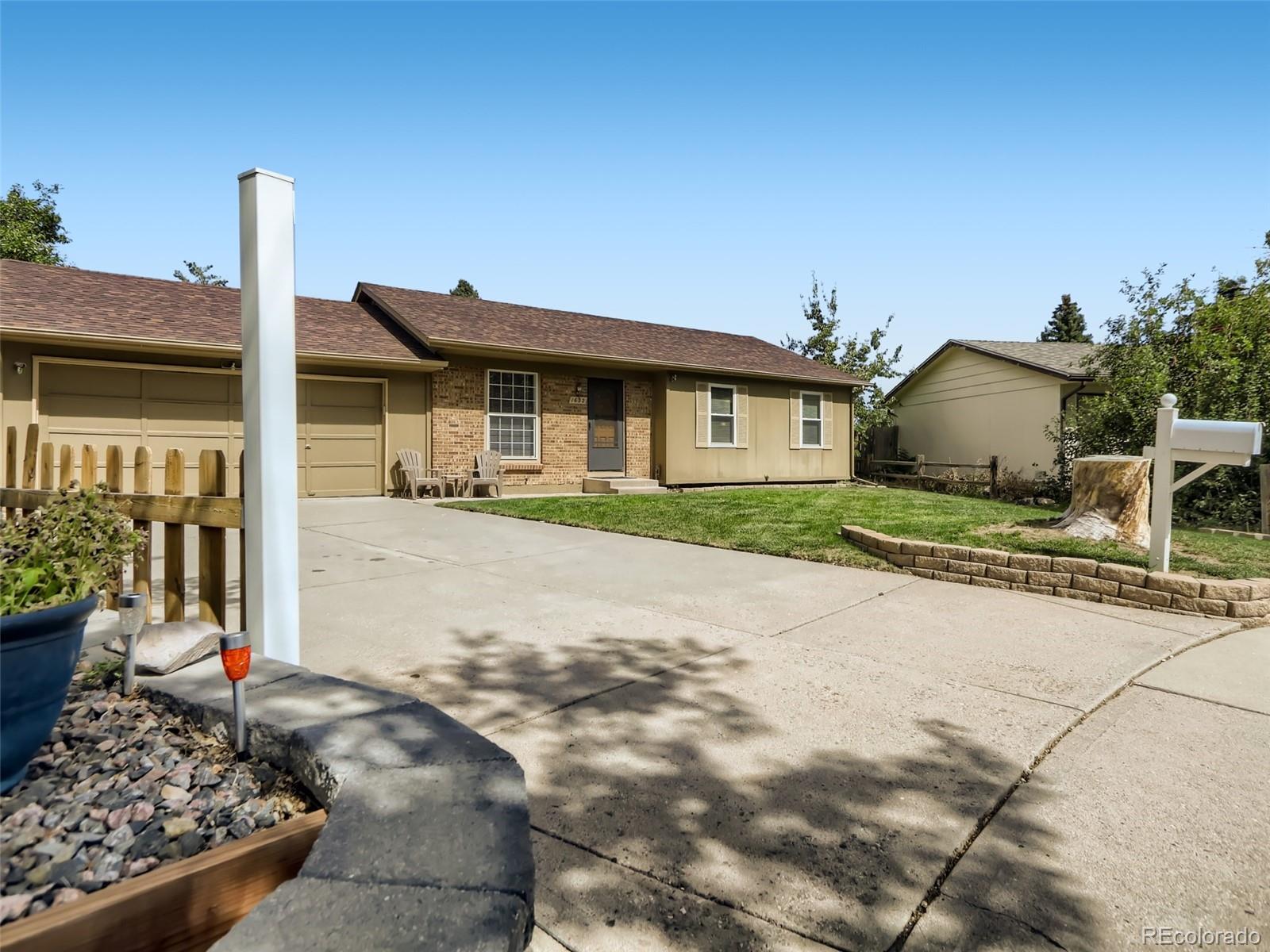 1632 South Rifle Street Aurora, CO 80017 - Photo 2 of 26 a front view of a house with garden